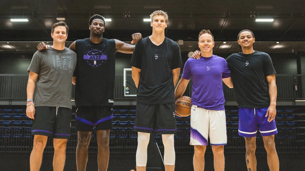 Utah Jazz players and coaches together on a practice court